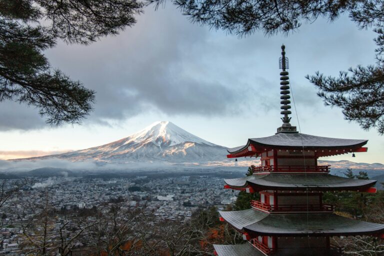 Japan Scenic view of Chureito Pagoda with snow-capped Mount Fuji under a cloudy sky in Fujinomiya, Japan.